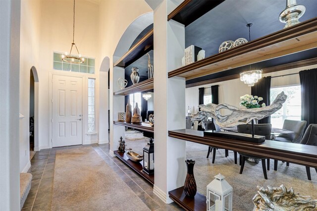 9801 Georgia Ave, Denton, TX 76207 - tiled entryway featuring arched walkways, a chandelier, a towering ceiling, and baseboards