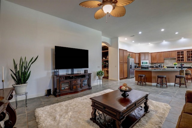 living room featuring ceiling fan and light tile patterned flooring