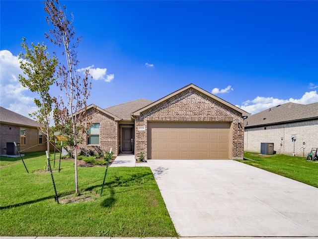 ranch-style home with a garage, a front lawn, and central air condition unit