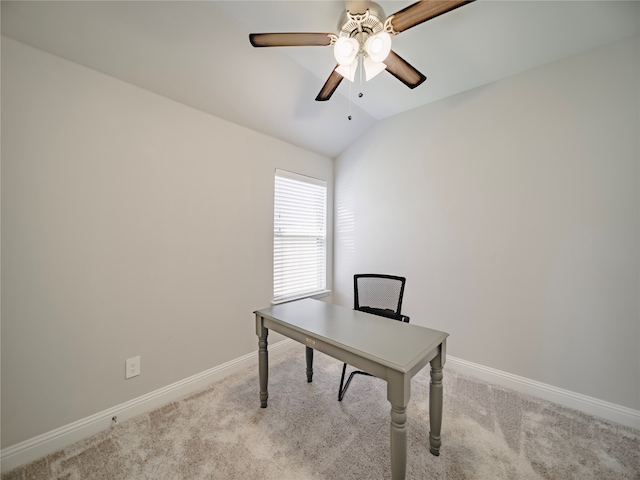 carpeted home office with ceiling fan and vaulted ceiling