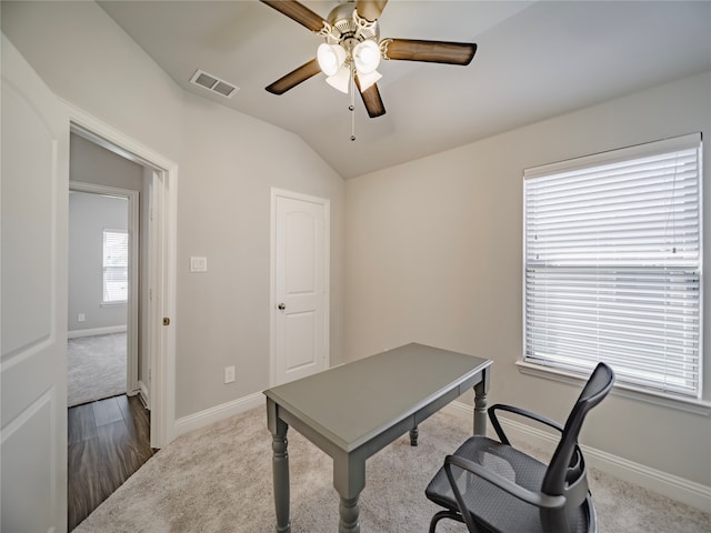 carpeted office space featuring lofted ceiling and ceiling fan