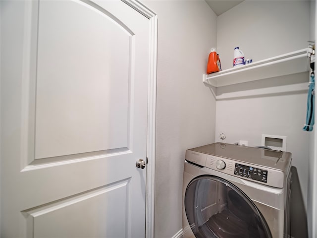 clothes washing area featuring washer / dryer