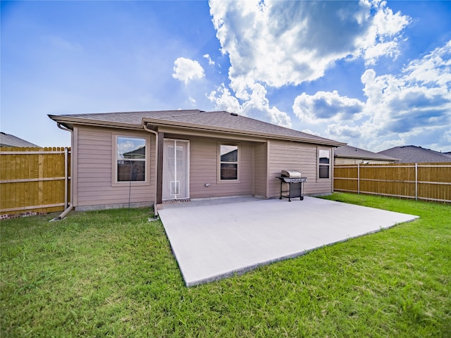 back of property with a patio and a lawn