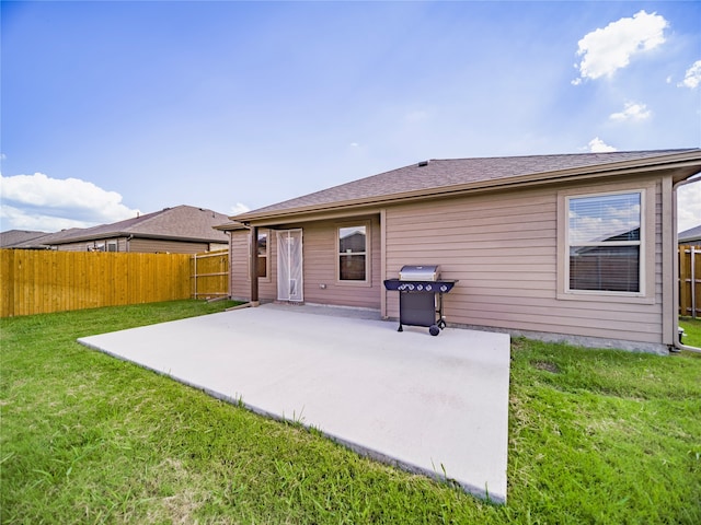 back of house featuring a yard and a patio