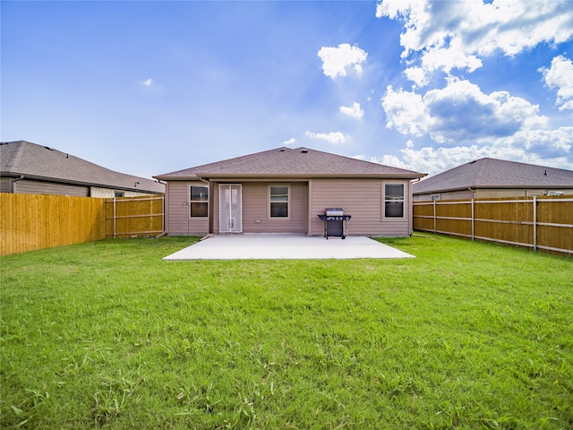 back of property featuring a patio and a yard