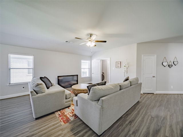 living room featuring dark hardwood / wood-style floors and ceiling fan