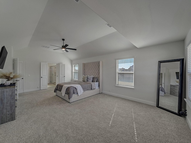 unfurnished bedroom featuring vaulted ceiling, light colored carpet, and ceiling fan