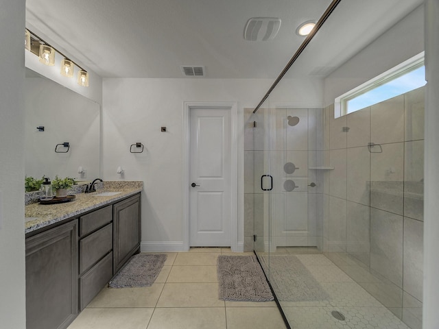 bathroom with tile patterned floors, an enclosed shower, and vanity