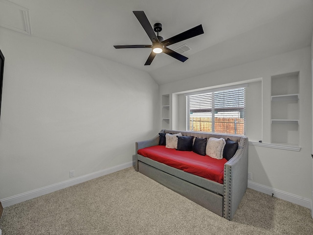 living area featuring vaulted ceiling, carpet flooring, ceiling fan, and built in shelves