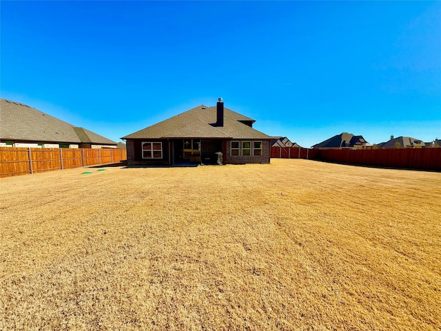 rear view of house with a yard