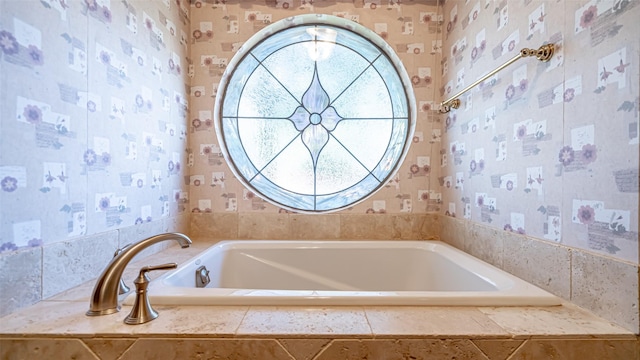 bathroom featuring tiled bath