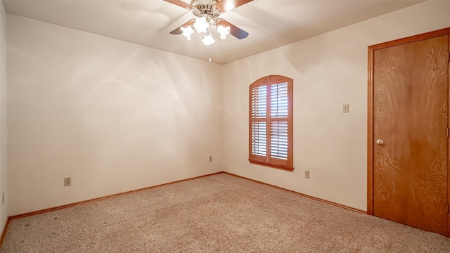 carpeted empty room featuring ceiling fan