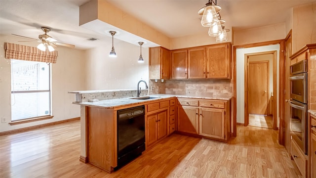 kitchen with pendant lighting, sink, black dishwasher, tasteful backsplash, and kitchen peninsula