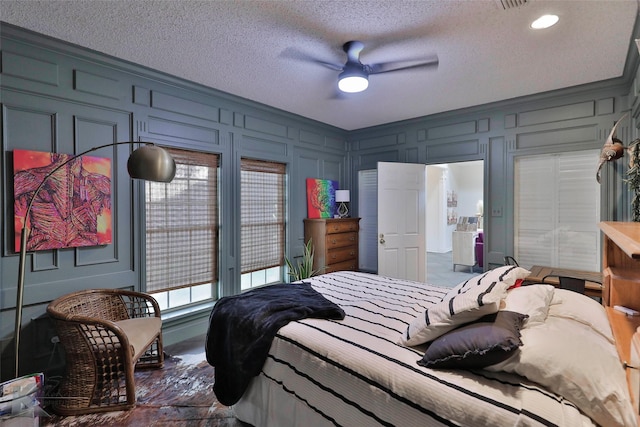 bedroom with crown molding, ceiling fan, and a textured ceiling