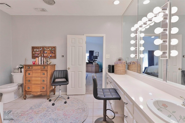 bathroom with vanity, tile patterned floors, and toilet