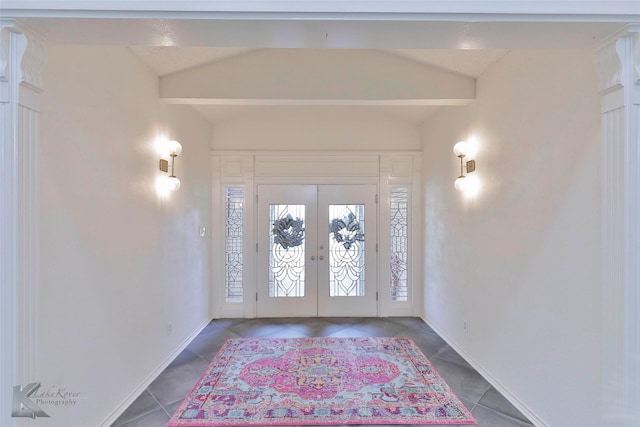 entrance foyer featuring vaulted ceiling, tile patterned floors, and french doors