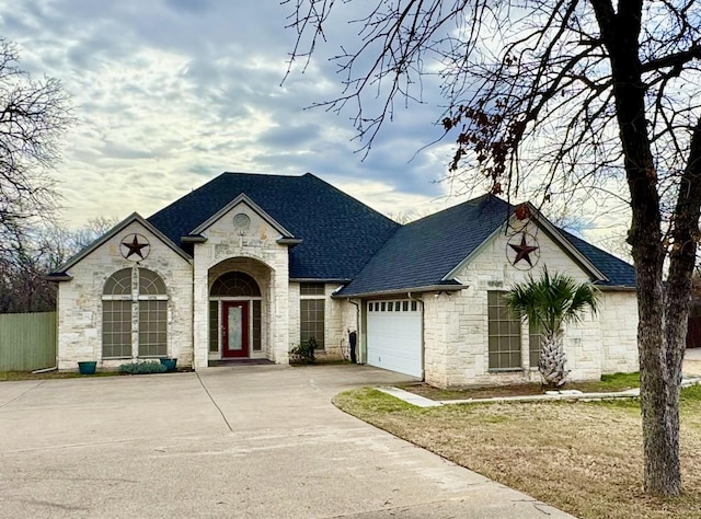 french country home with a garage