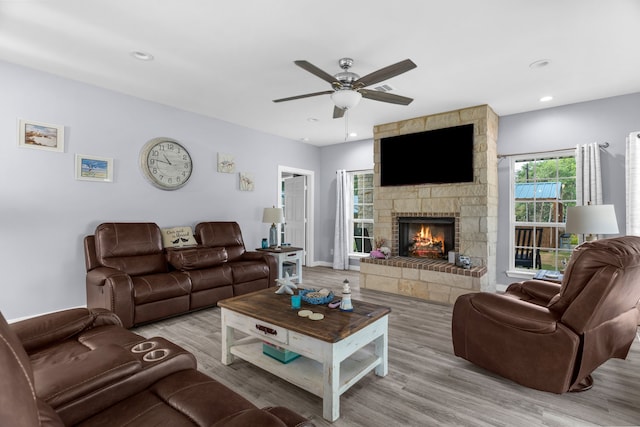 86593 N State Highway 289, Pottsboro, TX 75076 - living room featuring ceiling fan, a fireplace, and light wood-type flooring