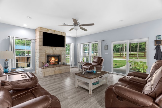 86593 N State Highway 289, Pottsboro, TX 75076 - living room with a fireplace, a wealth of natural light, light hardwood / wood-style flooring, and ceiling fan