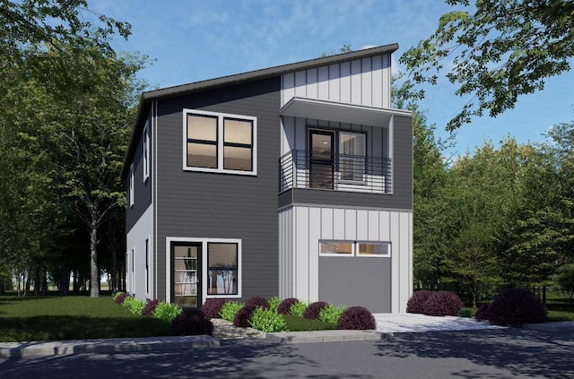 contemporary home with a garage and a balcony