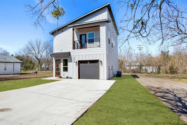 view of front of home with board and batten siding, concrete driveway, and a balcony