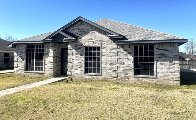 rear view of property with a yard