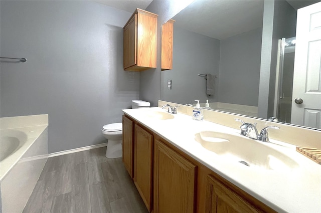 bathroom with vanity, a bathtub, wood-type flooring, and toilet