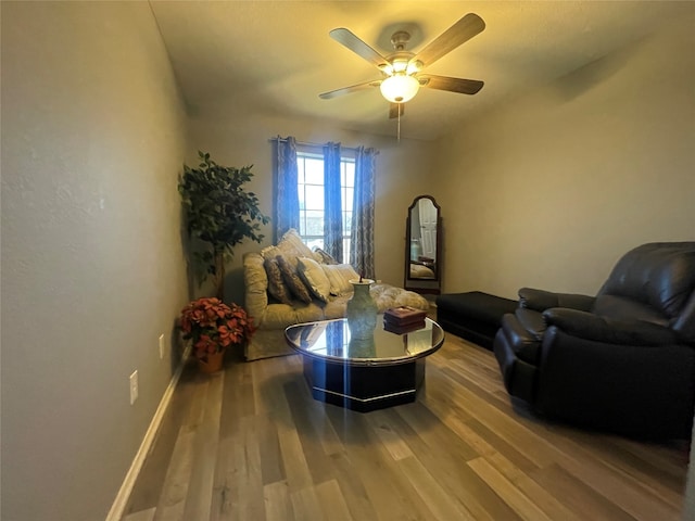 living room featuring hardwood / wood-style floors and ceiling fan