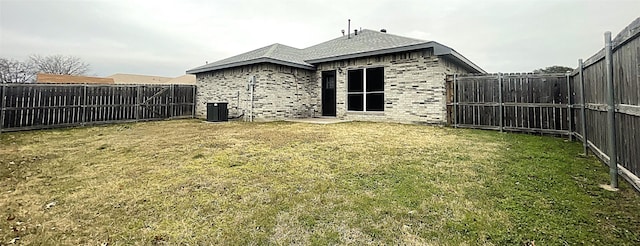 rear view of house featuring a lawn