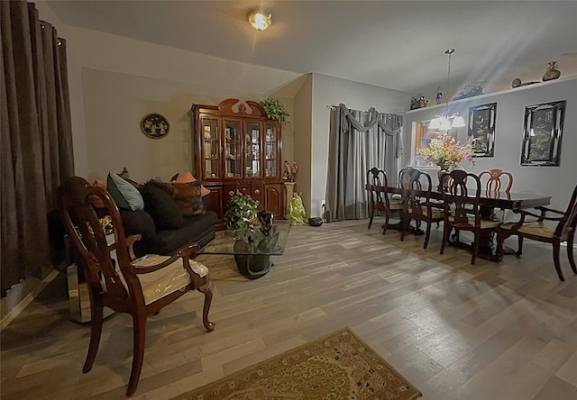 interior space featuring wood-type flooring and a chandelier