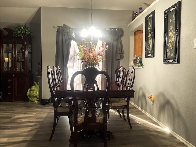 dining area featuring a notable chandelier and hardwood / wood-style flooring