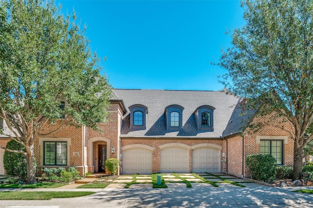 french country style house with a garage