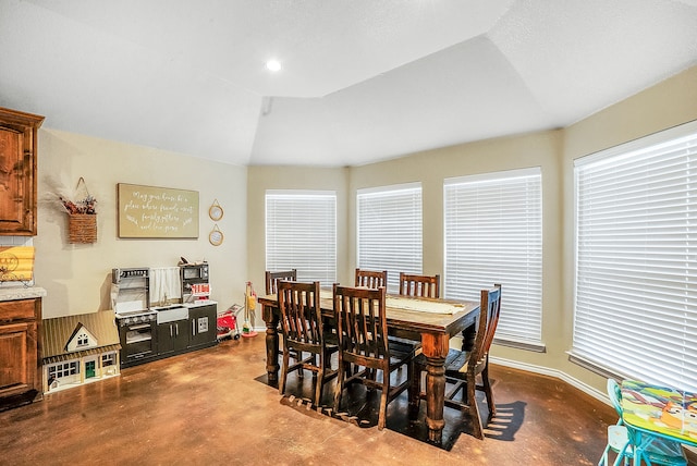 dining space featuring lofted ceiling