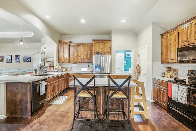 kitchen featuring tasteful backsplash, sink, pendant lighting, and black appliances