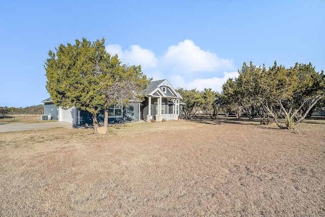 view of front of house with a garage, a sunroom, and a front yard