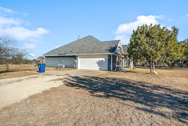 view of home's exterior featuring cooling unit, a garage, and a lawn