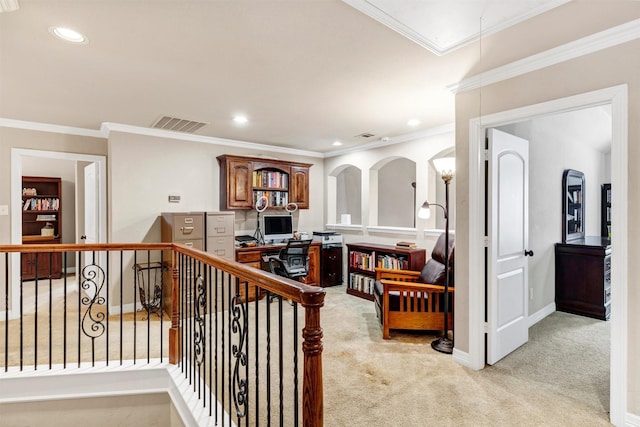 hall with light colored carpet and ornamental molding