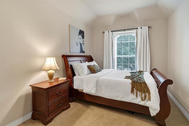 bedroom featuring vaulted ceiling and light colored carpet