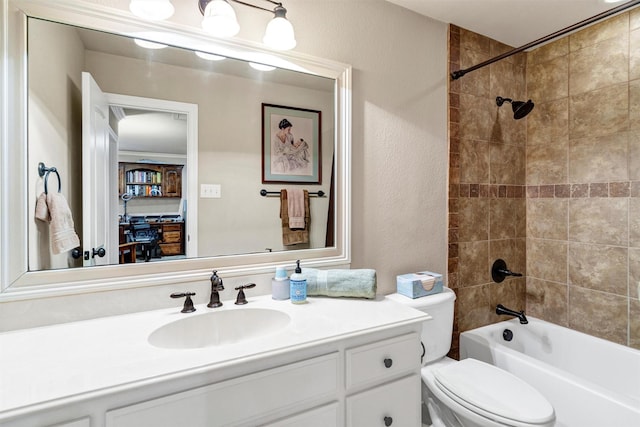 full bathroom featuring vanity, toilet, and tiled shower / bath combo