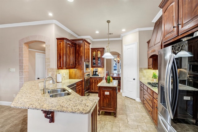 kitchen featuring sink, appliances with stainless steel finishes, tasteful backsplash, decorative light fixtures, and kitchen peninsula