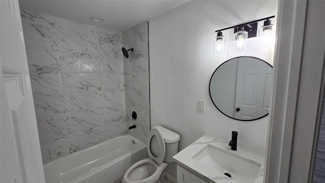 full bathroom with tiled shower / bath, vanity, and toilet