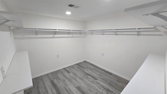 spacious closet featuring dark hardwood / wood-style flooring