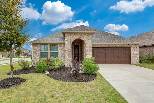 view of front of home with a garage and a front yard