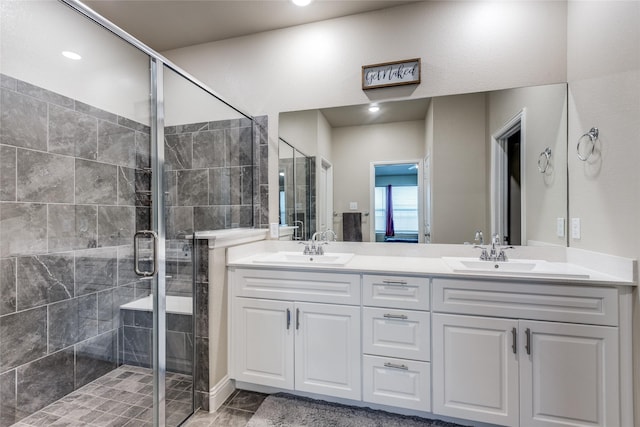 bathroom featuring vanity and a shower with shower door