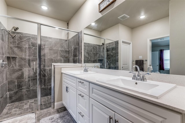 bathroom featuring vanity and a shower with door