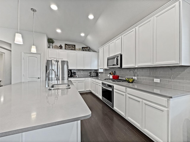 kitchen with white cabinetry, appliances with stainless steel finishes, sink, and hanging light fixtures