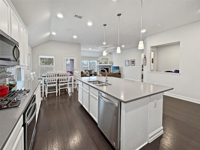 kitchen with white cabinetry, an island with sink, appliances with stainless steel finishes, and sink