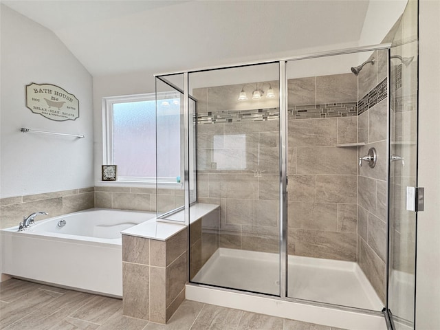 bathroom featuring lofted ceiling and plus walk in shower