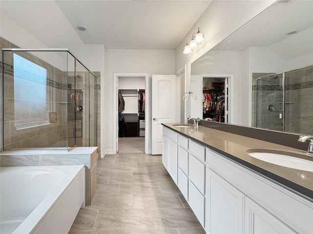 bathroom featuring vanity and independent shower and bath