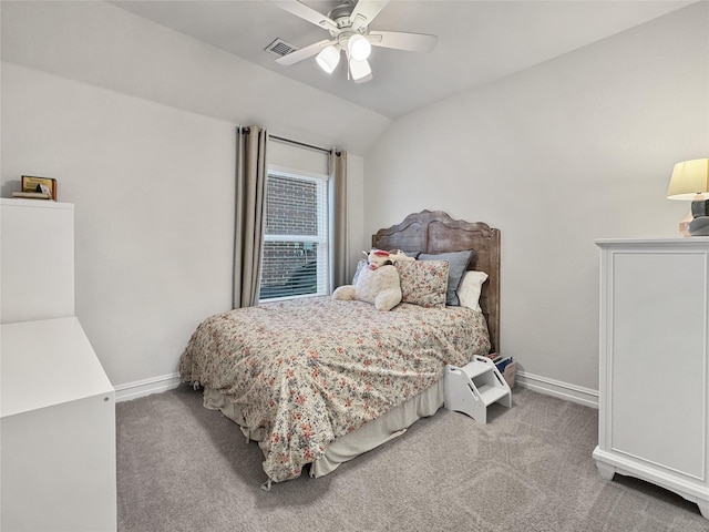 bedroom with vaulted ceiling, light colored carpet, and ceiling fan